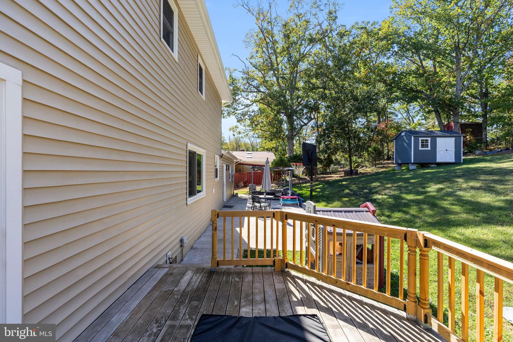 6666 Kelly Road Warrenton, VA 20187 - Photo 24 of 34 a view of a wooden deck and a yard