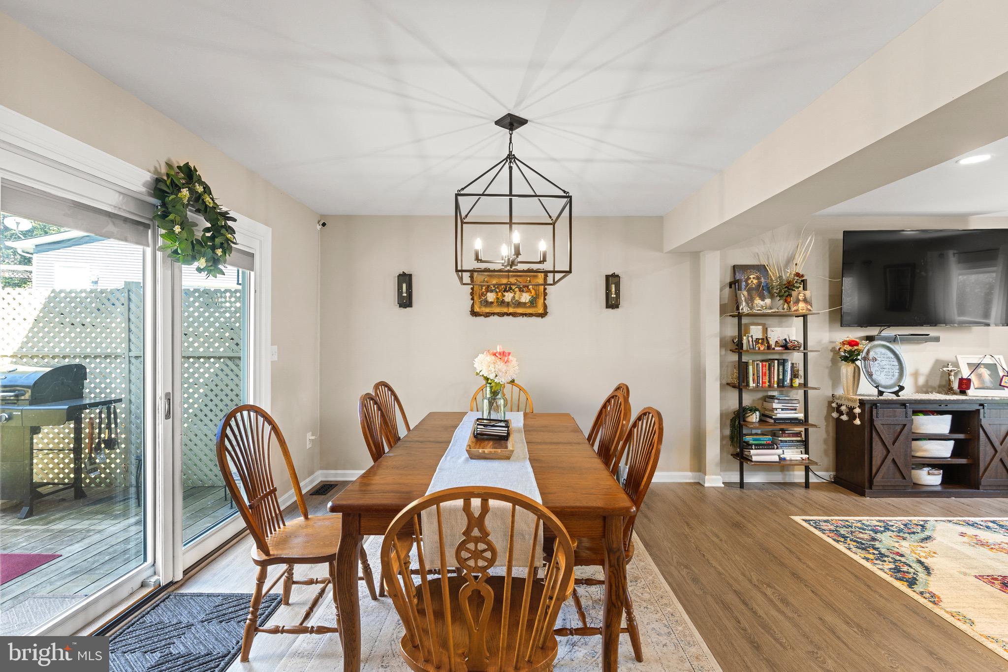 6666 Kelly Road Warrenton, VA 20187 - Photo 6 of 34 a dining room with furniture a chandelier and wooden floor