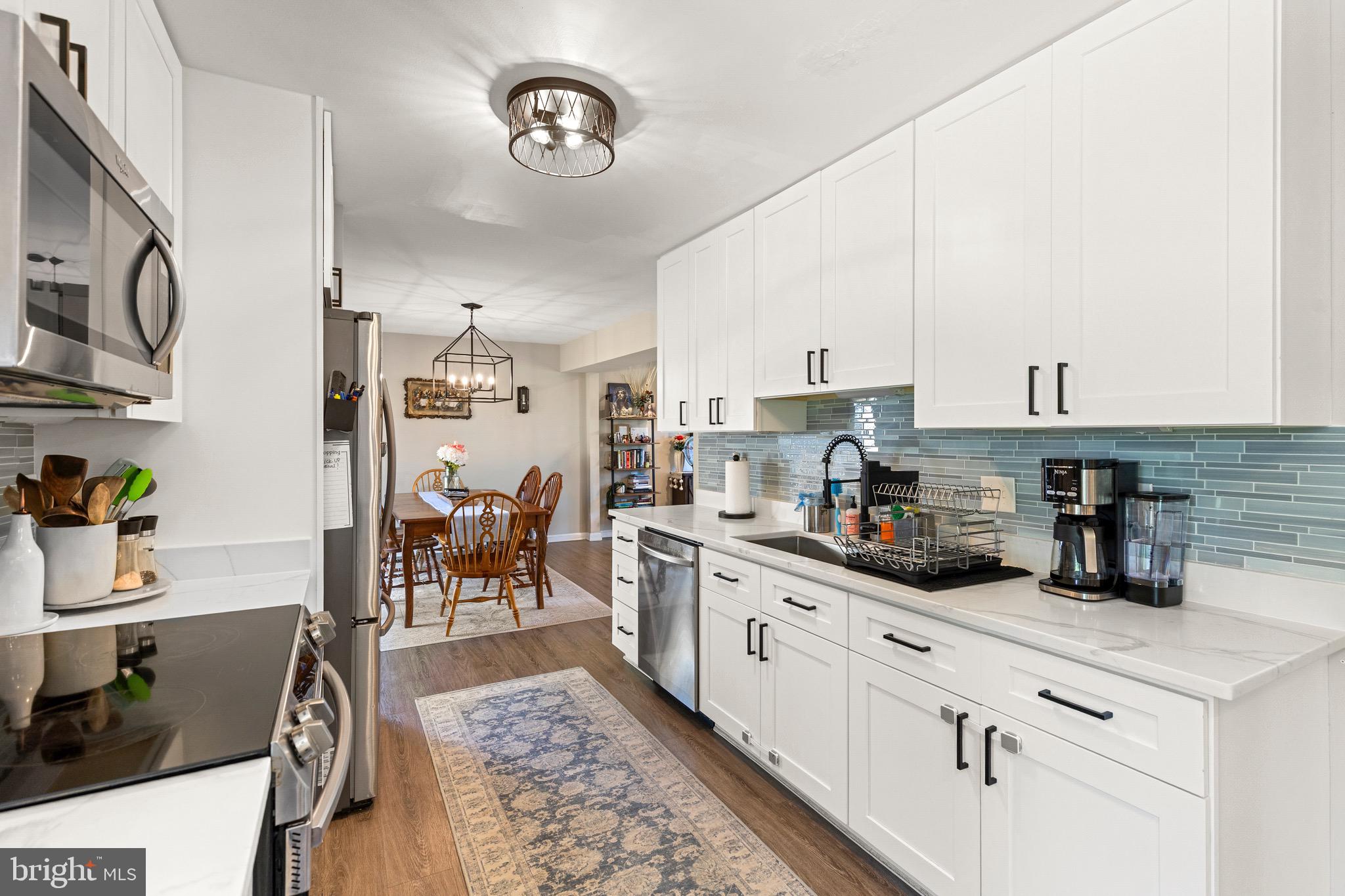 6666 Kelly Road Warrenton, VA 20187 - Photo 9 of 34 a kitchen with stainless steel appliances granite countertop a stove top oven a sink a counter space and cabinets
