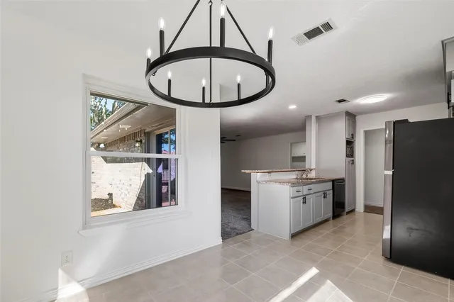 a kitchen with stainless steel appliances granite countertop a stove a refrigerator and a microwave