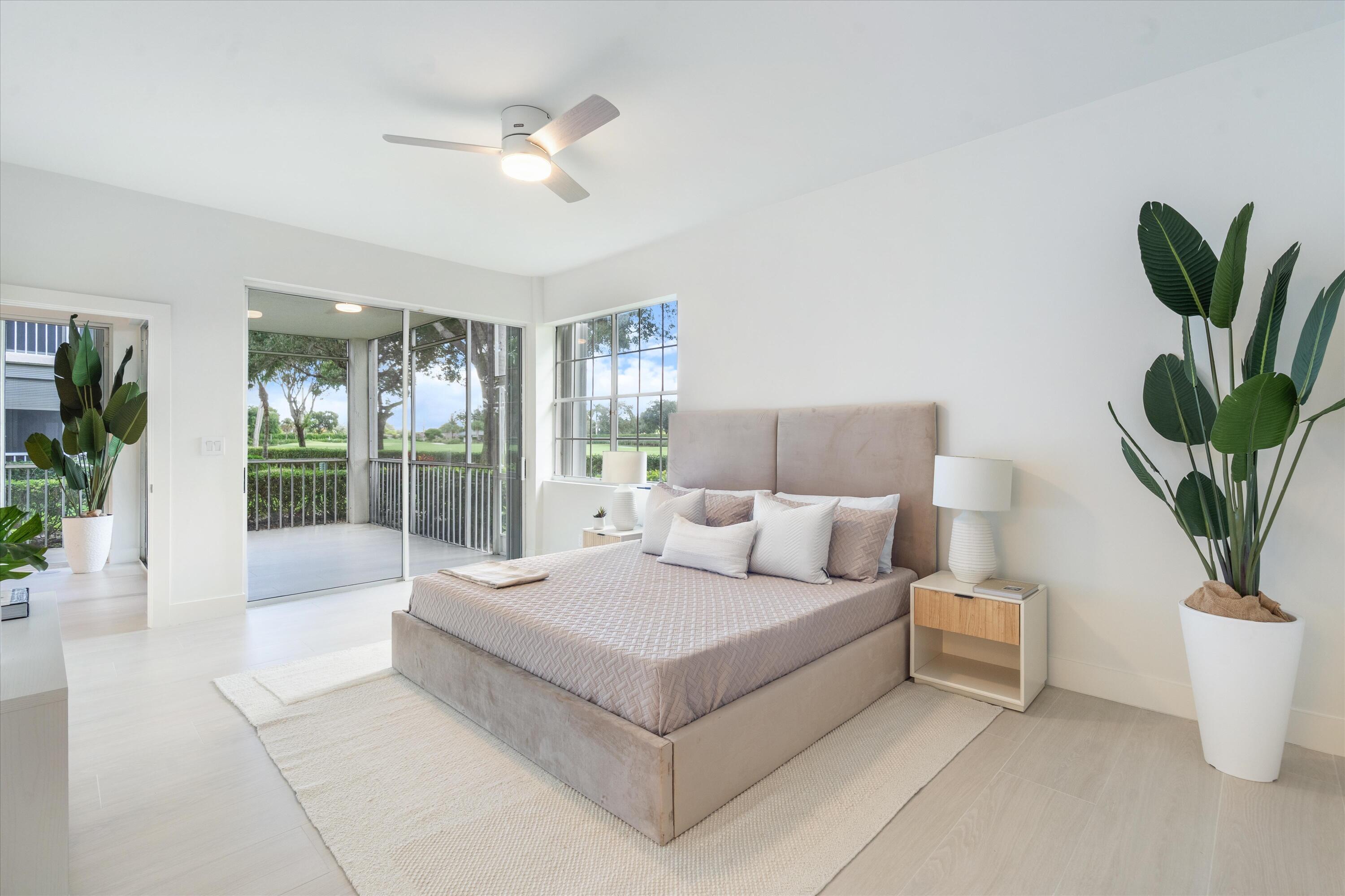 5154 Lake Catalina Drive, Unit A Boca Raton, FL 33496 - Photo 13 of 51 a living room with furniture a chandelier and a potted plant