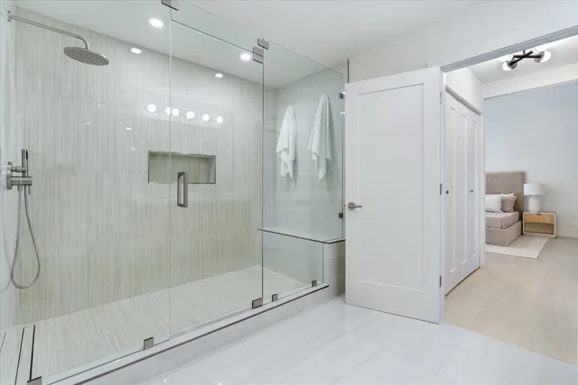 a bathroom with a shower and a glass door