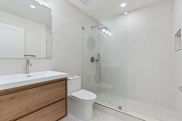 a bathroom with a shower a sink a toilet and shower