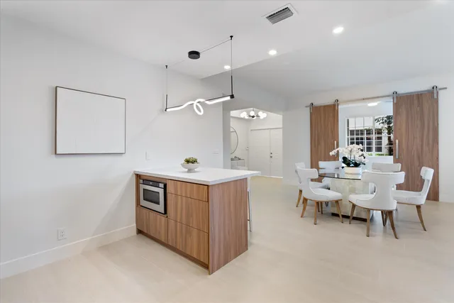 a living room with furniture a dining table and chairs