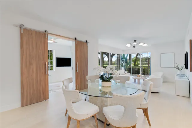a view of a dining room with furniture wooden floor and chandelier