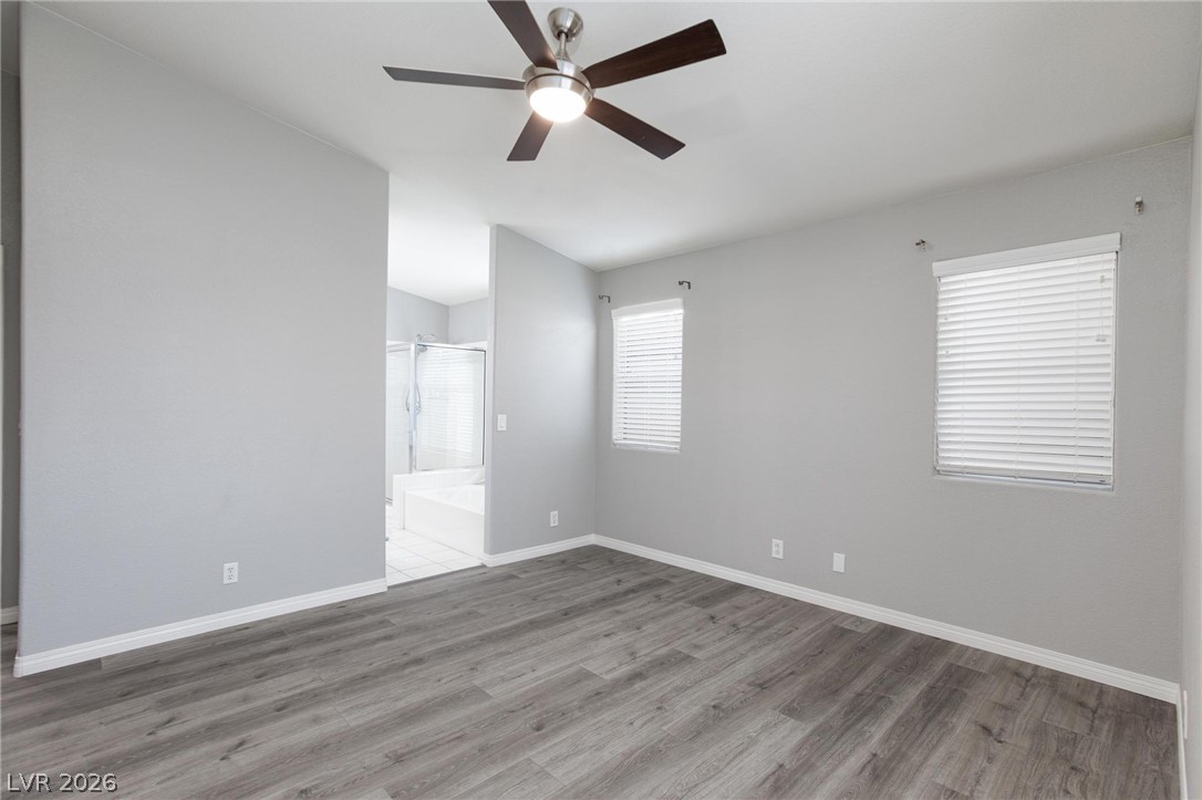 2254 Ramsgate Drive Henderson, NV 89074 - Photo 15 of 43 A quiet retreat, this bedroom offers modern flooring and an adjoining private bath.