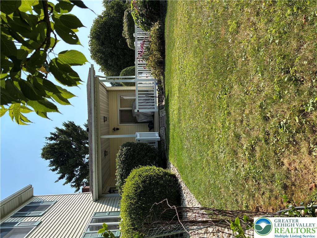 3843 Eagle Road Slatington, PA 18080 - Photo 11 of 47 A welcoming front porch, adorned with white railings, overlooks a well-maintained lawn.