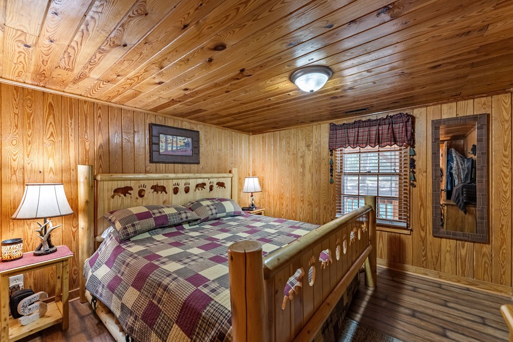 134 Ebenezer Road Ellijay, GA 30536 - Photo 34 of 85 a bed room with a bed and a lamp