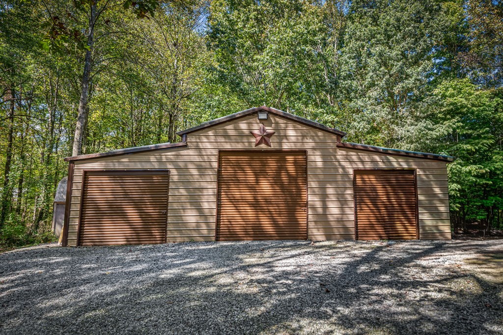 134 Ebenezer Road Ellijay, GA 30536 - Photo 8 of 85 a front view of a house with a yard and garage