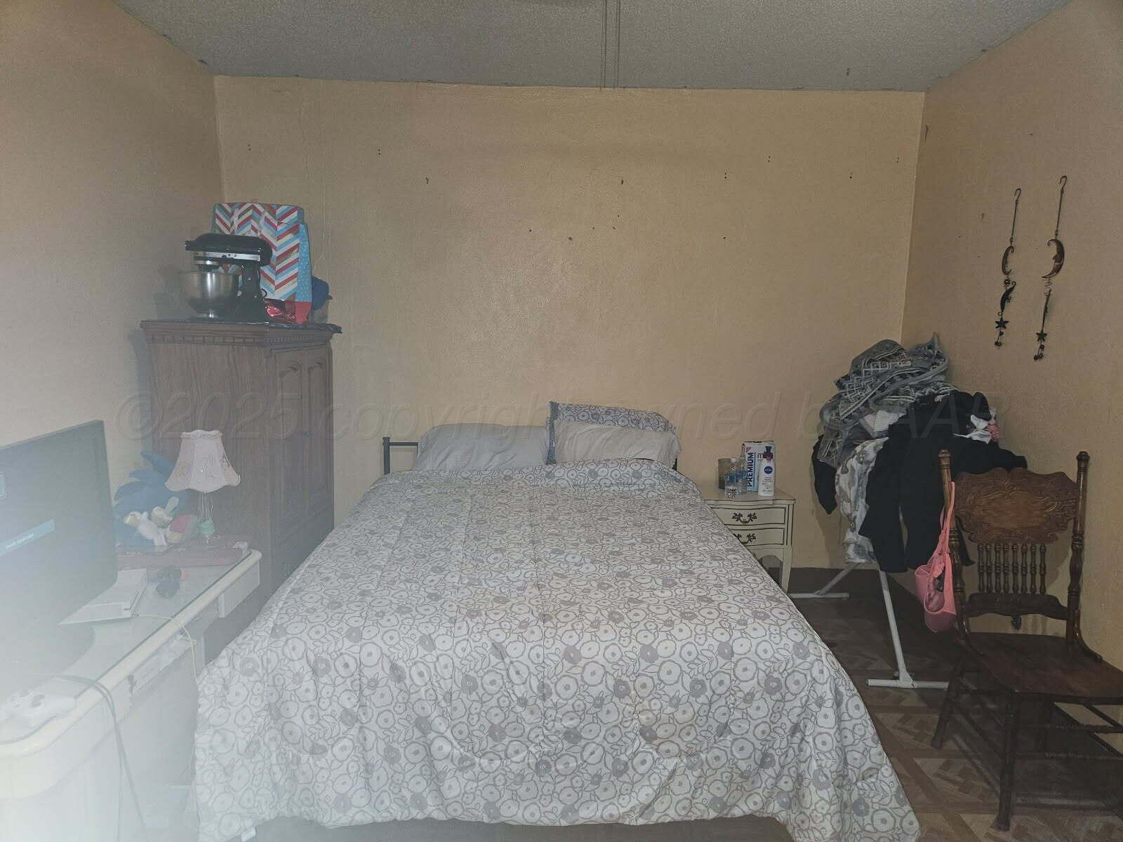 418 South Main Street Borger, TX 79007 - Photo 13 of 41 a bedroom with a bed and cabinets