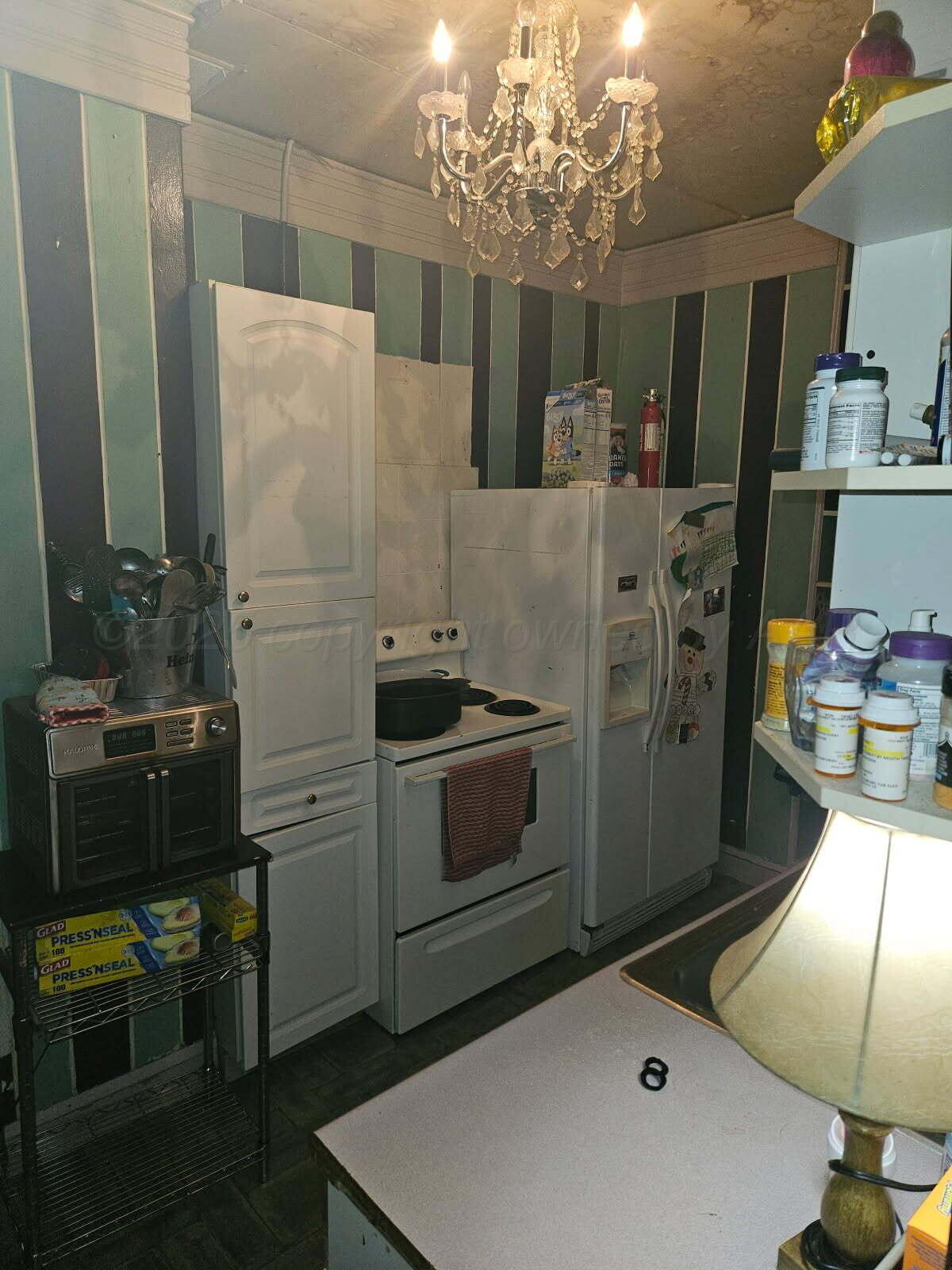 418 South Main Street Borger, TX 79007 - Photo 15 of 41 a kitchen with stainless steel appliances kitchen island granite countertop a sink and cabinets