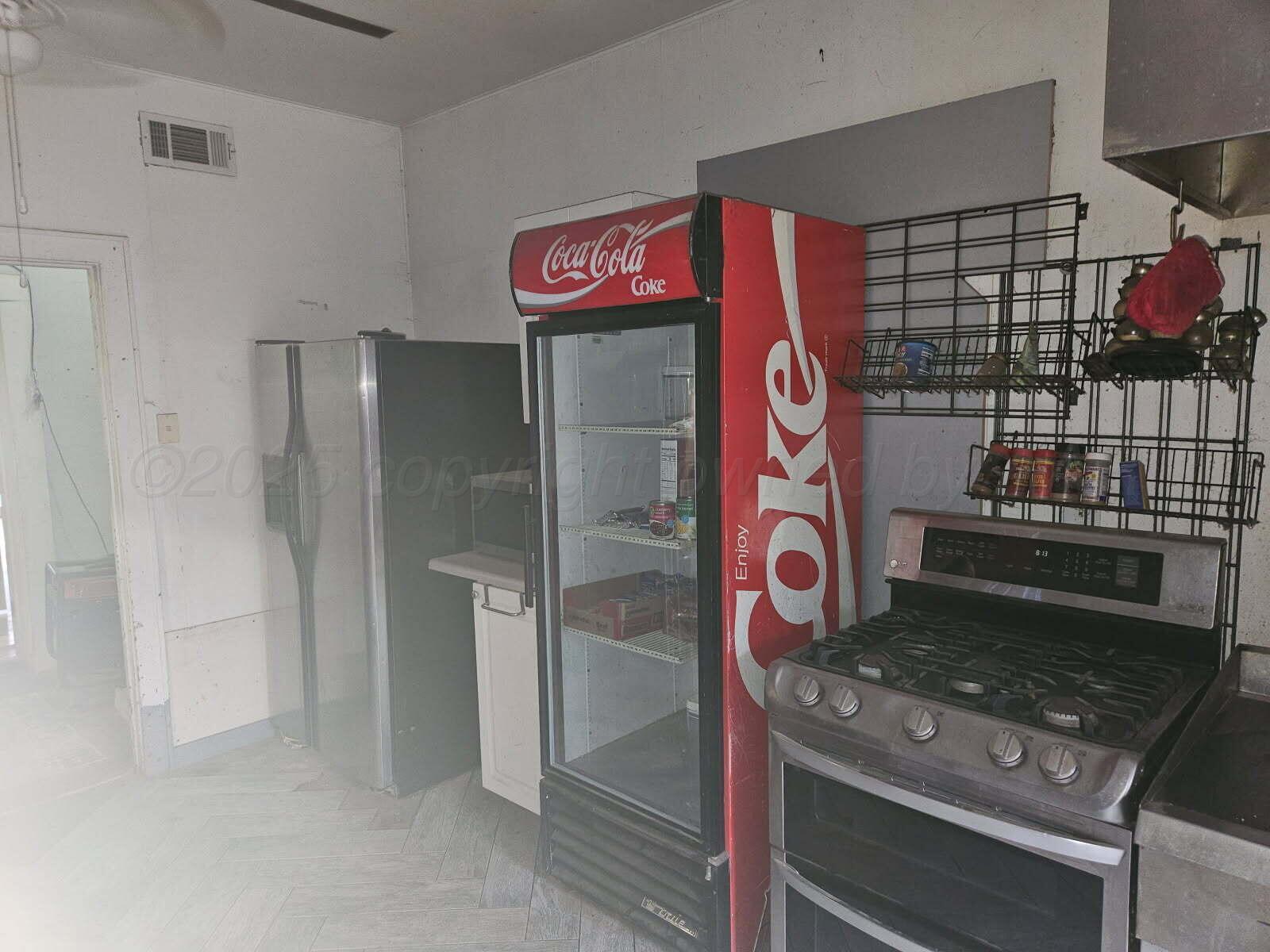 418 South Main Street Borger, TX 79007 - Photo 34 of 41 a kitchen with stainless steel appliances granite countertop a stove and a refrigerator