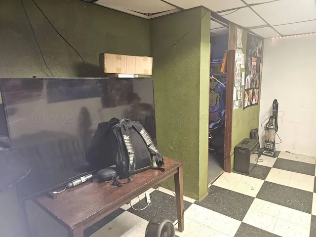 a room with a sink and a stove with wooden floor