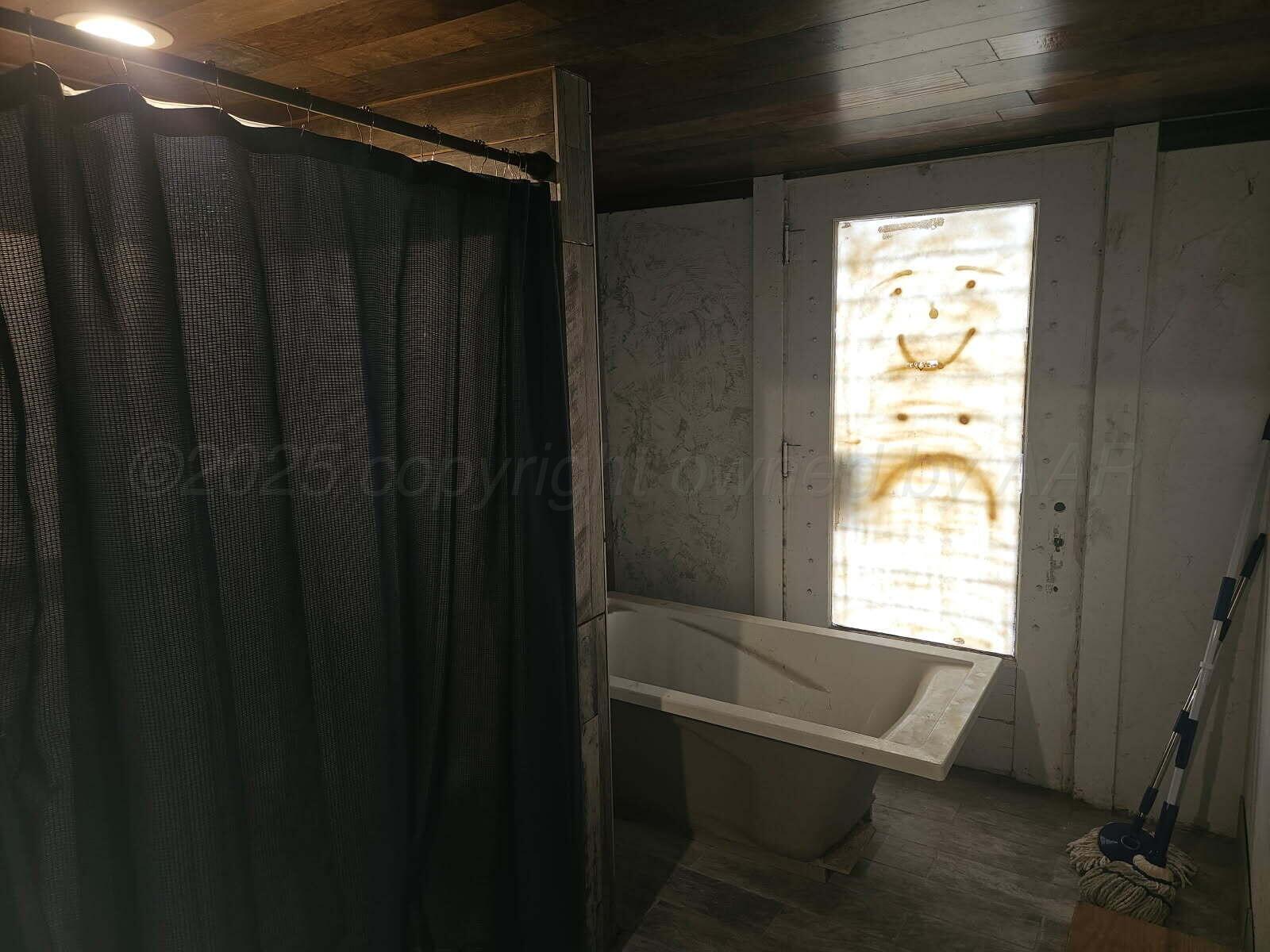 418 South Main Street Borger, TX 79007 - Photo 37 of 41 a bathroom with a window and a shower