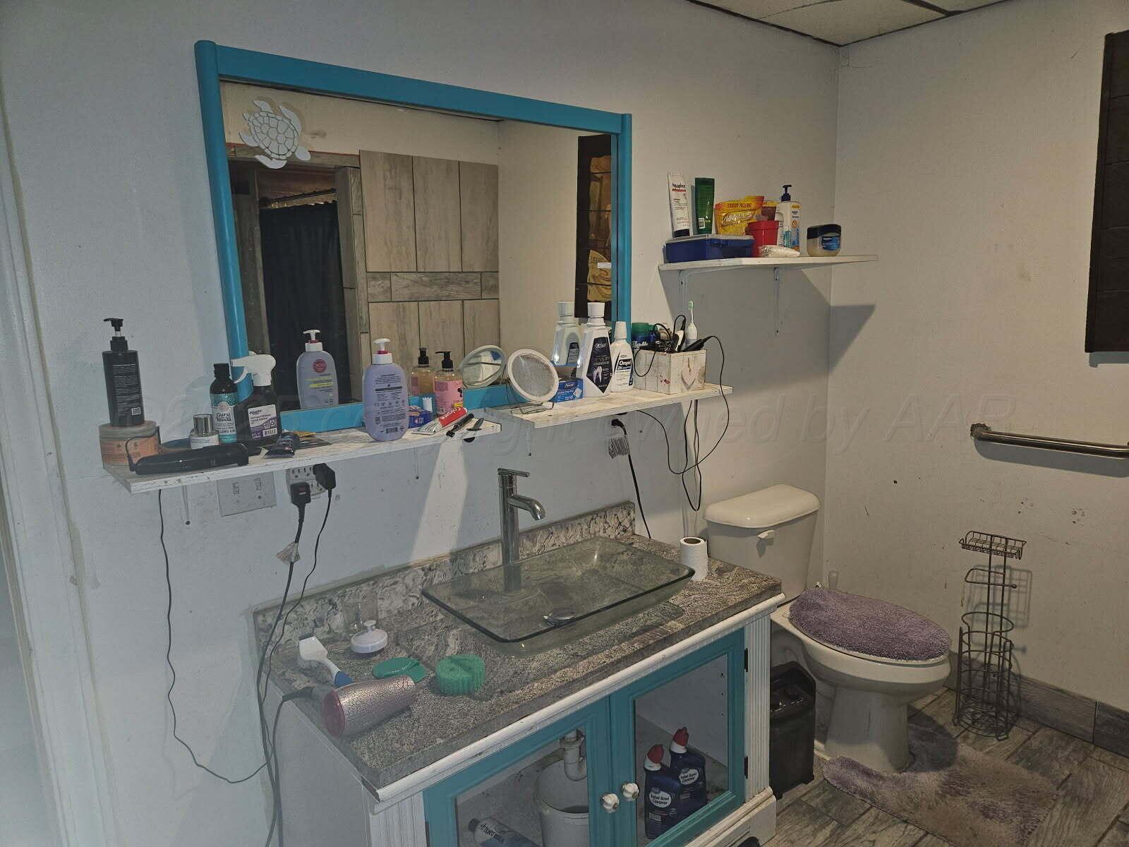 418 South Main Street Borger, TX 79007 - Photo 38 of 41 a room with a sink and a stove with wooden floor