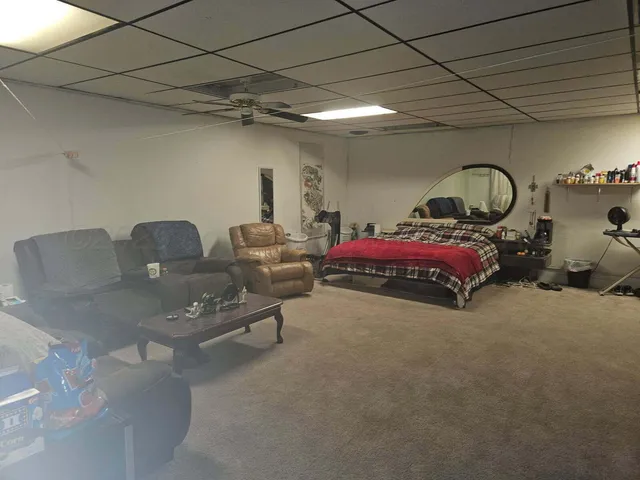 a backyard of a house with barbeque oven and wooden fence