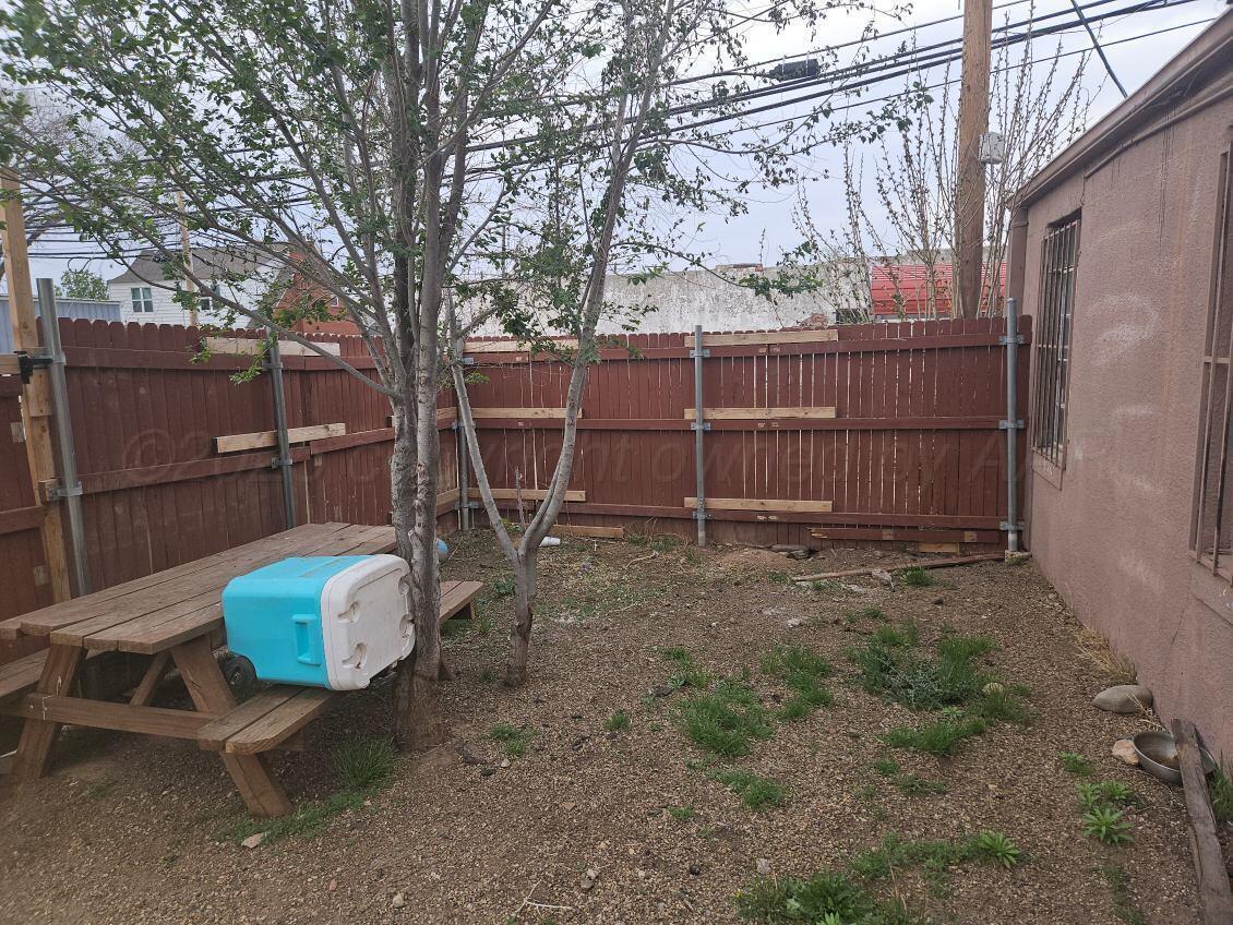 418 South Main Street Borger, TX 79007 - Photo 41 of 41 a backyard of a house with barbeque oven and wooden fence