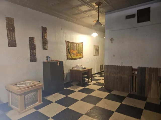 a room with a black white checkered floor with a black white checkered floor