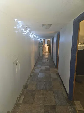 a view of a hallway with chandelier