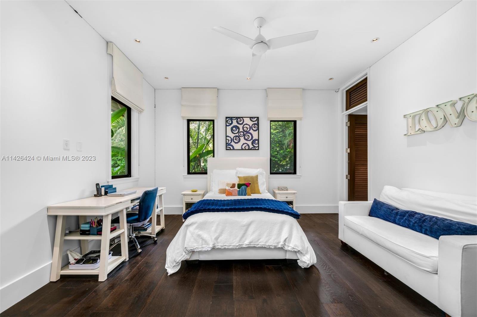 8601 Ponce De Leon Road Miami, FL 33143 - Photo 15 of 39 a bedroom with a bed and a wooden floor