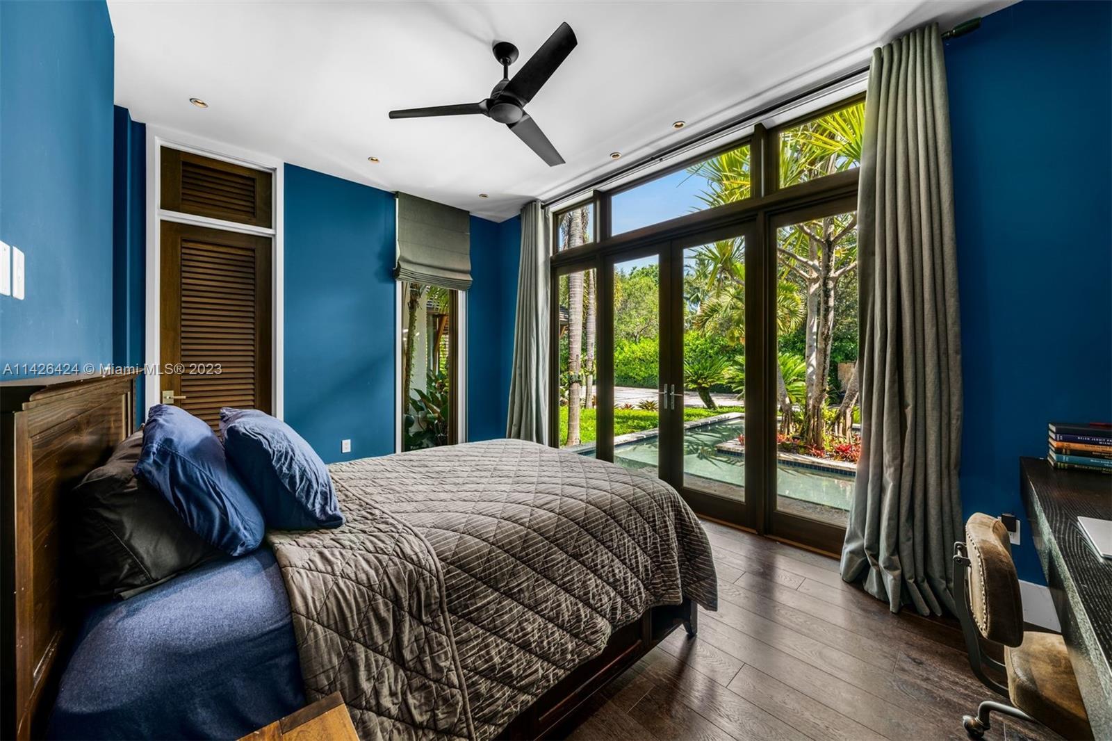 8601 Ponce De Leon Road Miami, FL 33143 - Photo 16 of 39 a bed sitting in a bedroom next to a window