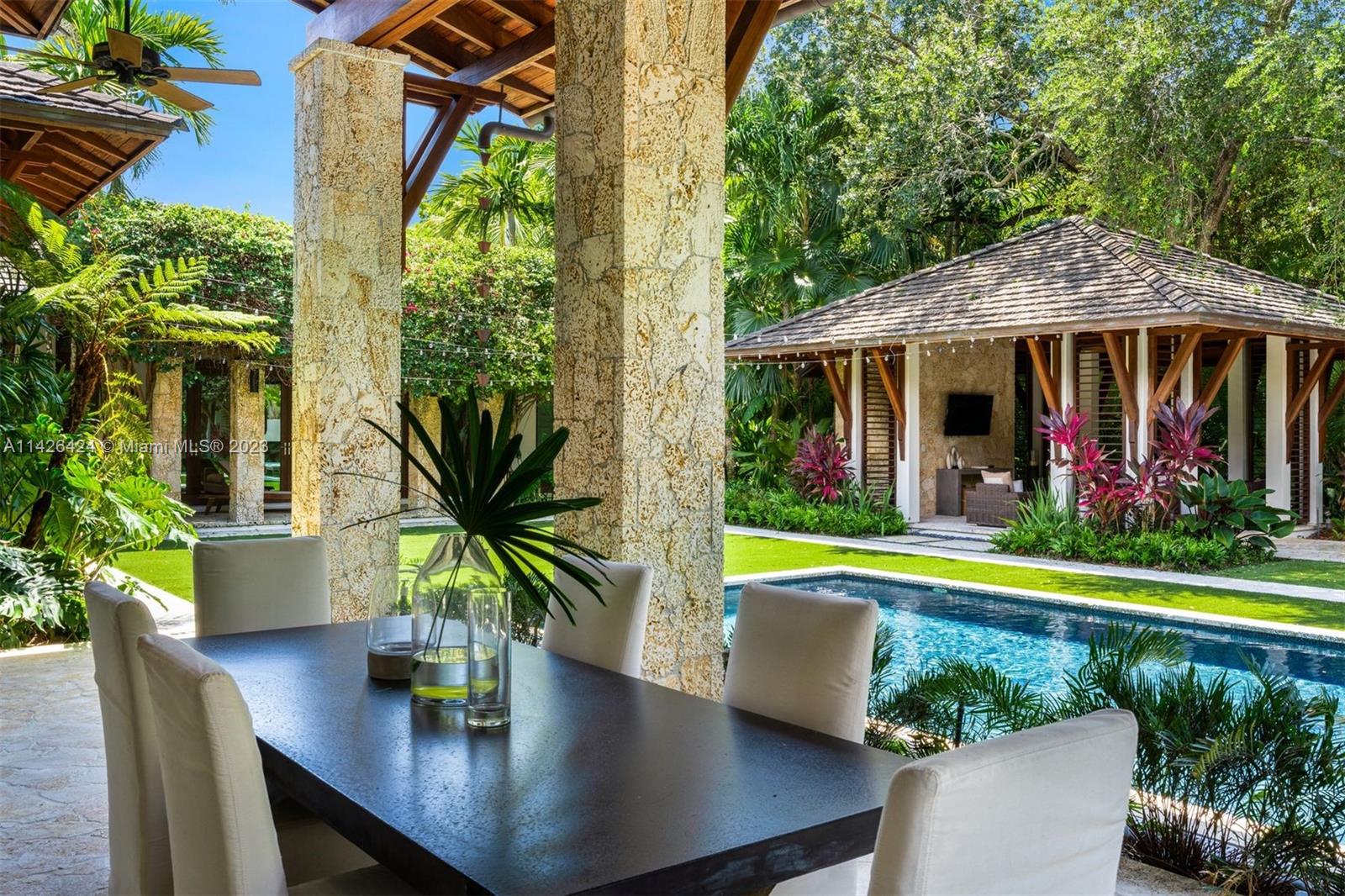 8601 Ponce De Leon Road Miami, FL 33143 - Photo 20 of 39 a view of a house with swimming pool and a yard