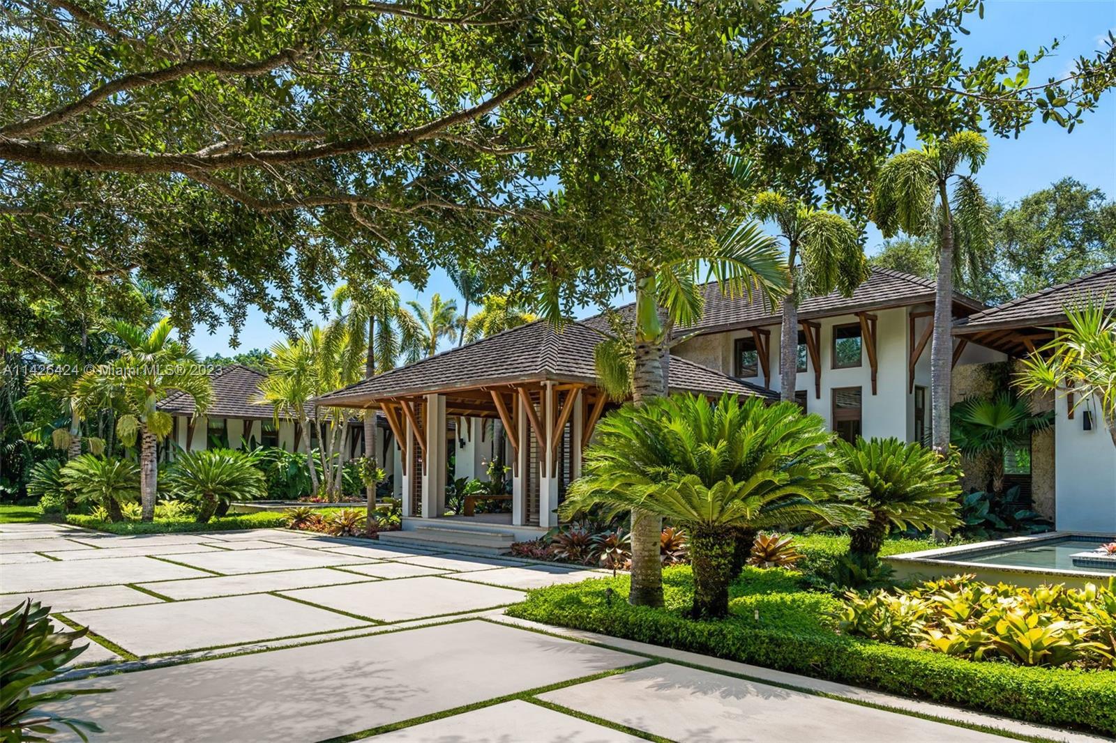 8601 Ponce De Leon Road Miami, FL 33143 - Photo 2 of 39 a view of a white house with a large tree