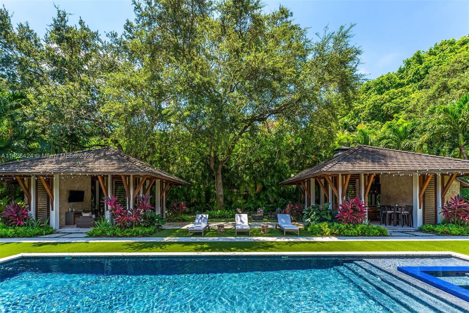 8601 Ponce De Leon Road Miami, FL 33143 - Photo 22 of 39 a front view of a house with a yard and swimming pool