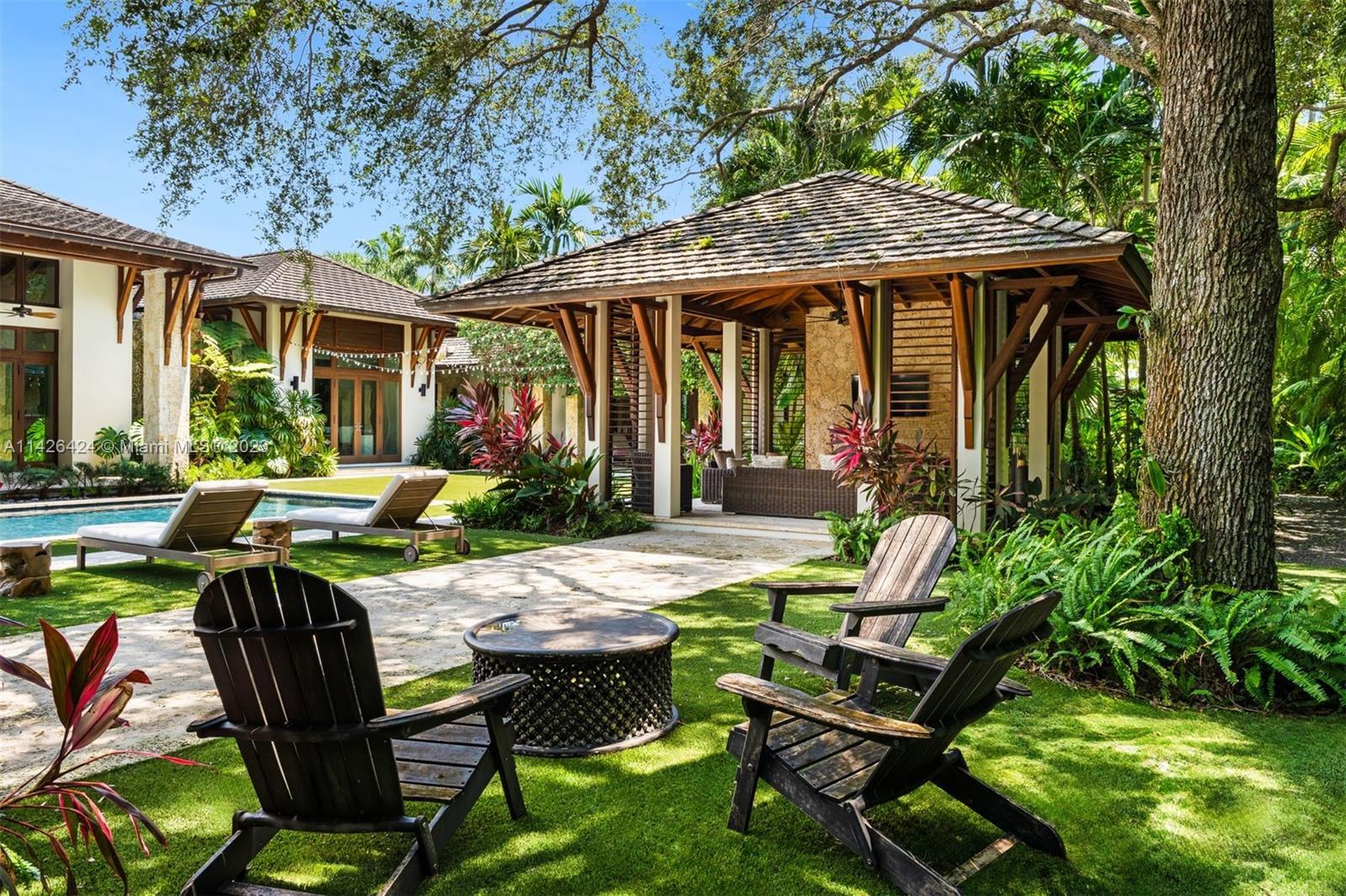 8601 Ponce De Leon Road Miami, FL 33143 - Photo 23 of 39 a patio with a table and chairs and potted plants