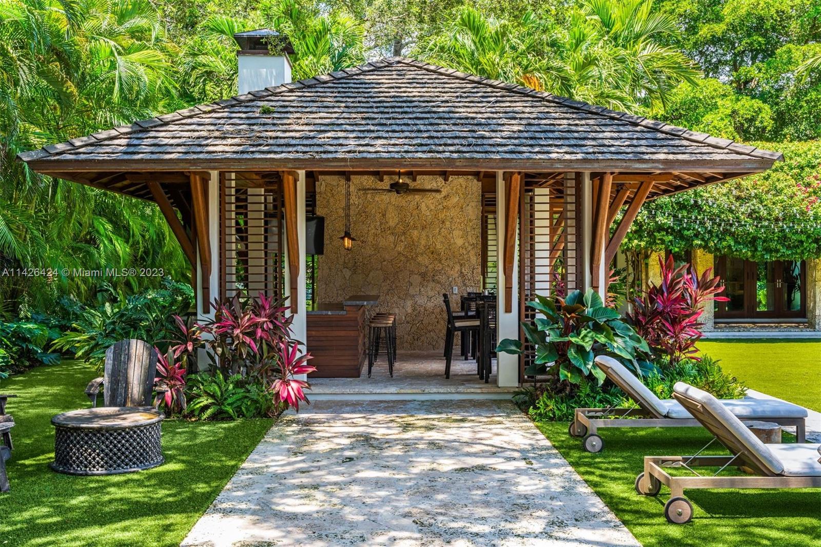 8601 Ponce De Leon Road Miami, FL 33143 - Photo 24 of 39 a patio with a table and chairs under an umbrella