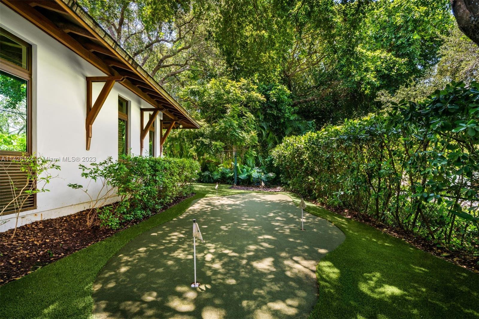 8601 Ponce De Leon Road Miami, FL 33143 - Photo 33 of 39 a backyard of a house with plants and garden