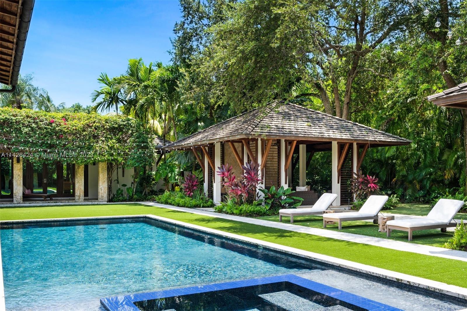 8601 Ponce De Leon Road Miami, FL 33143 - Photo 37 of 39 a view of swimming pool with lawn chairs under an umbrella