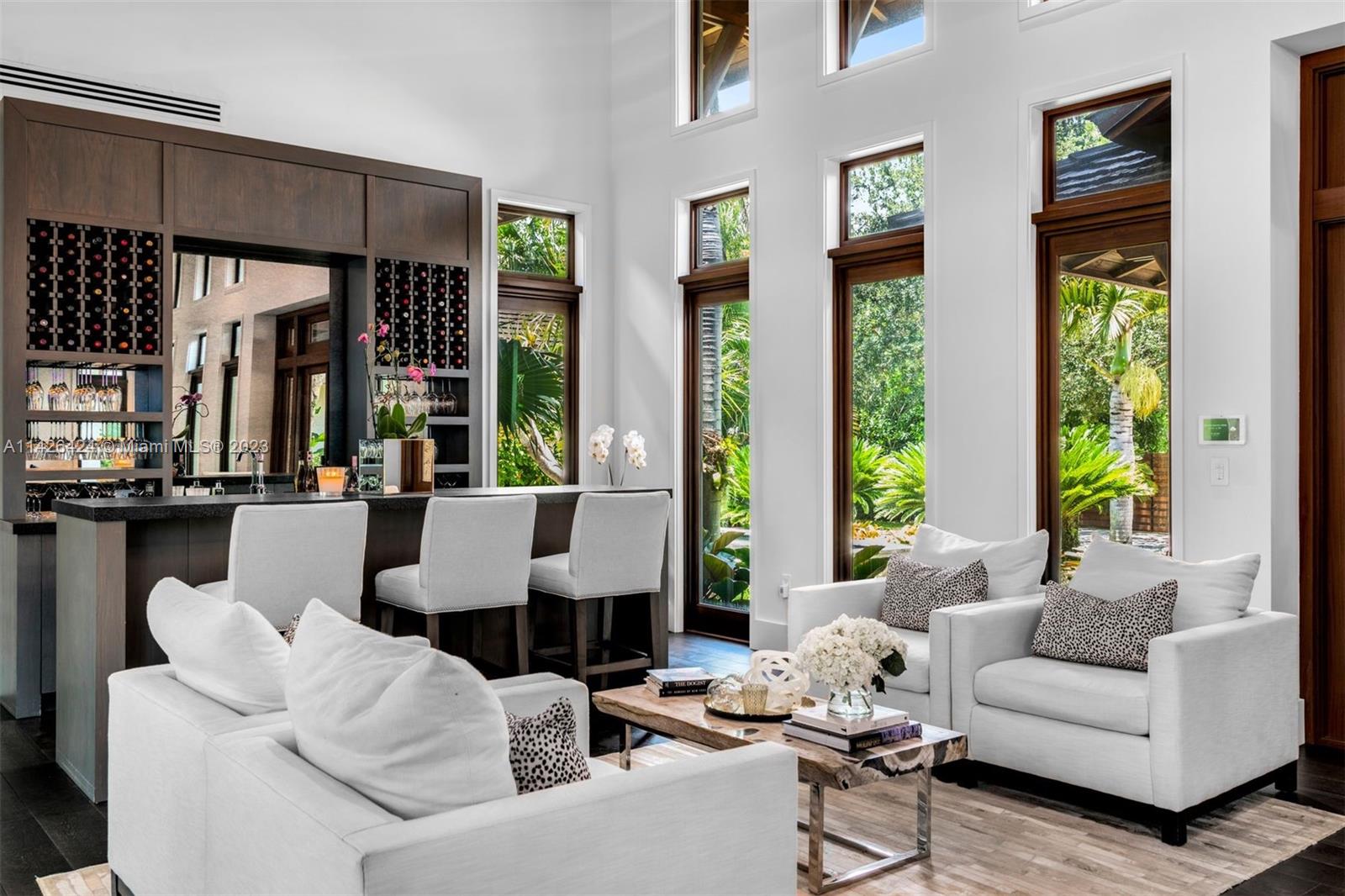 8601 Ponce De Leon Road Miami, FL 33143 - Photo 5 of 39 a living room with furniture and large windows