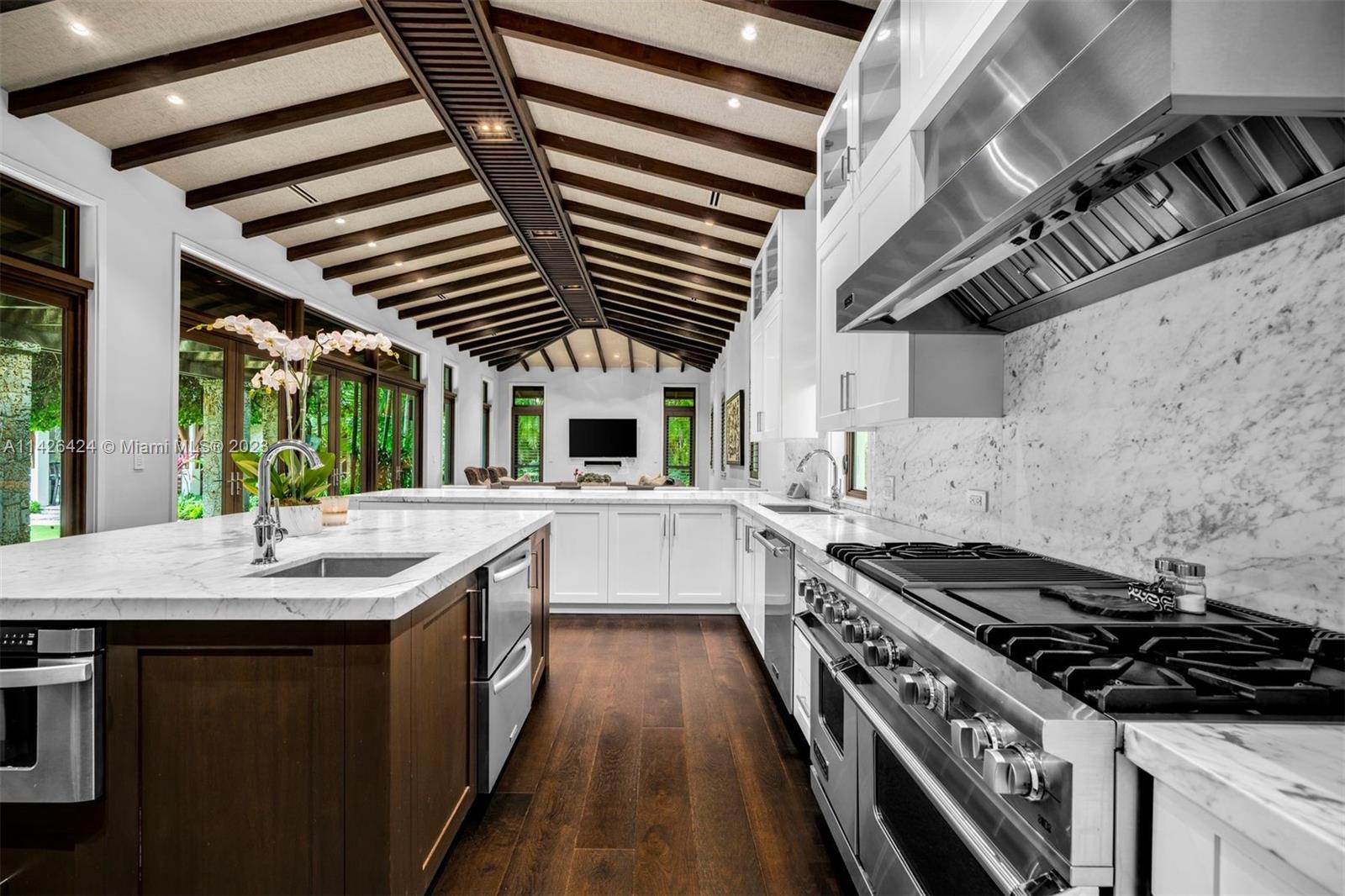 8601 Ponce De Leon Road Miami, FL 33143 - Photo 8 of 39 a kitchen with stainless steel appliances granite countertop a stove and a sink