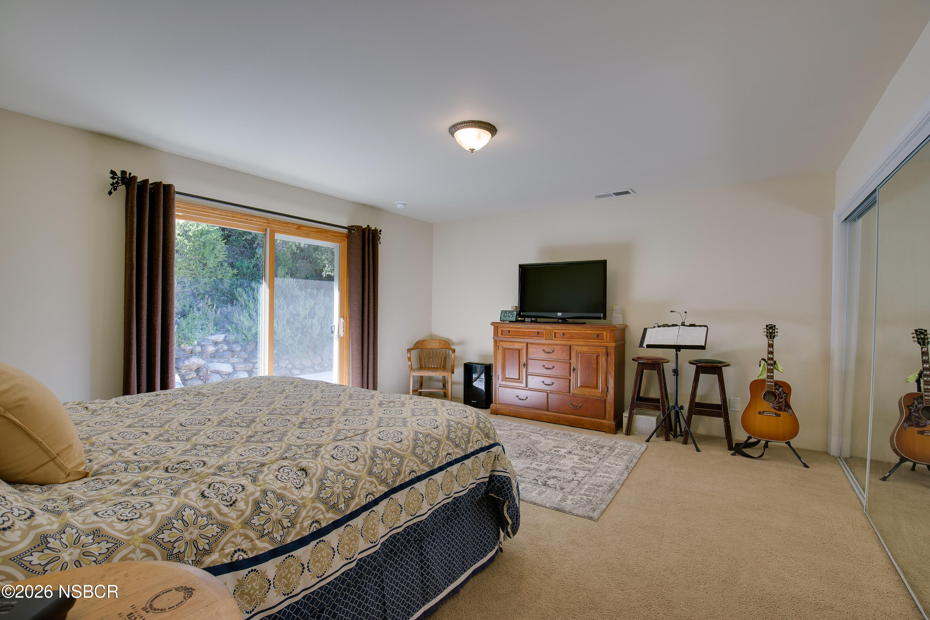 850 Fredensborg Canyon Road Solvang, CA 93463 - Photo 10 of 26 a bedroom with a bed and large windows