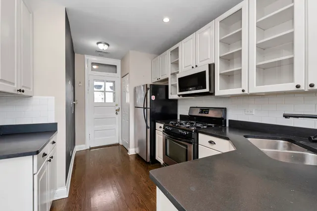 a bedroom with bed and a large window