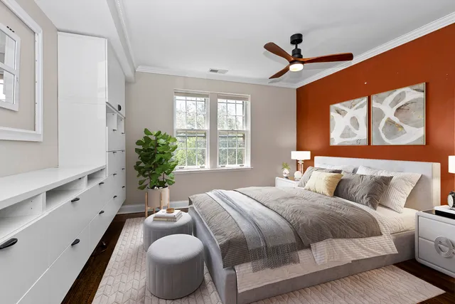 a bedroom with a bed and a large mirror with a potted plant