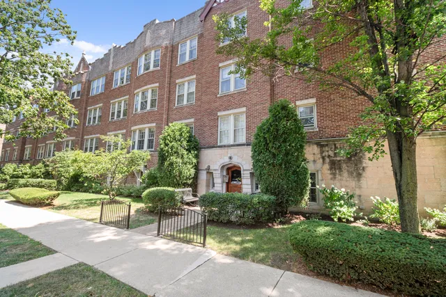 a view of a brick building next to a yard
