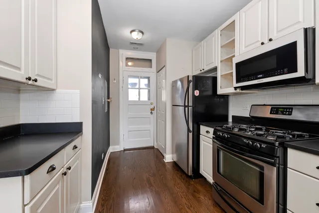 a kitchen with stainless steel appliances a stove microwave and a refrigerator