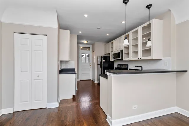 a kitchen with stainless steel appliances granite countertop a stove a sink and a refrigerator