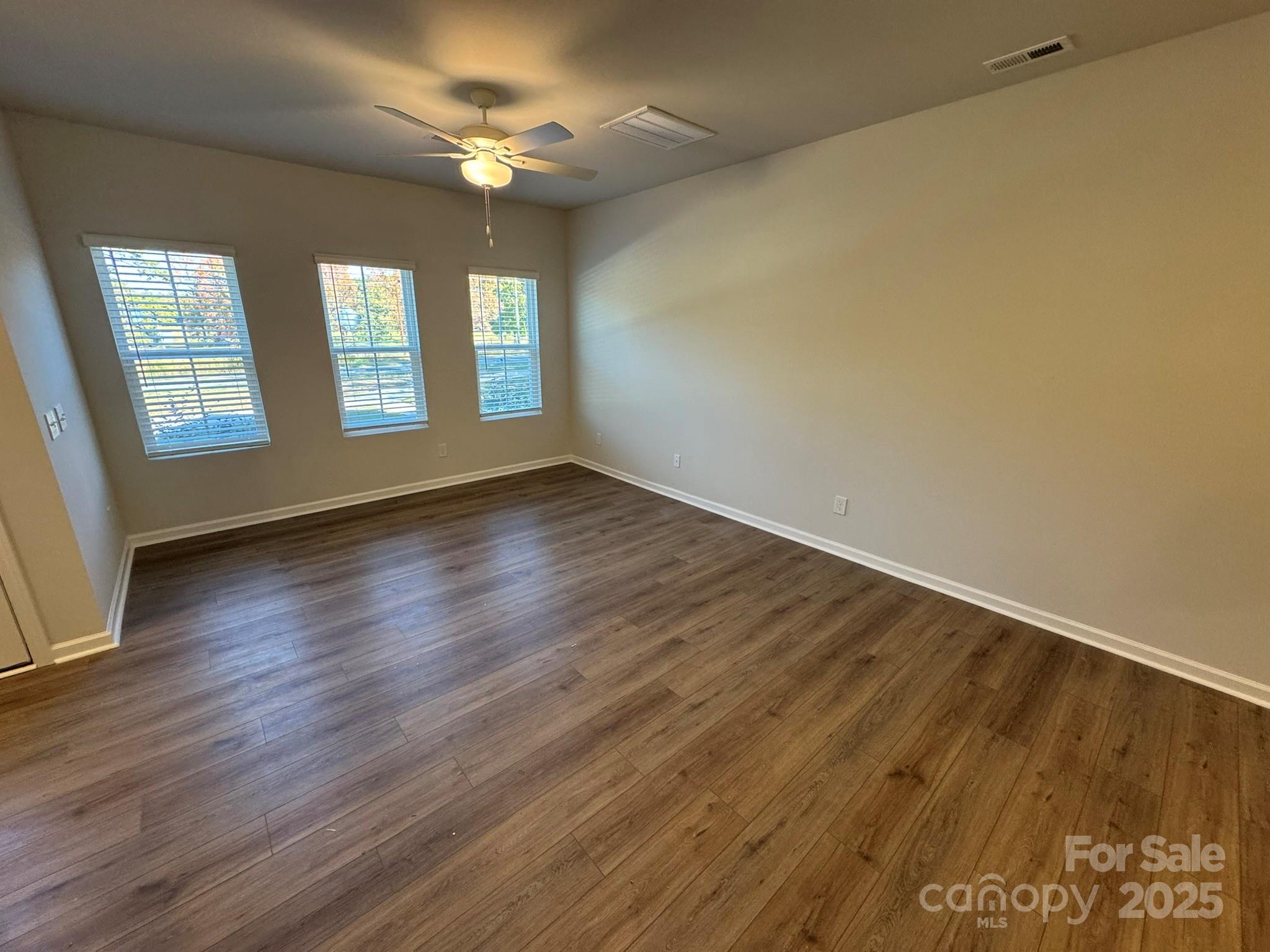 4750 Lakeview Road, Unit 18 Charlotte, NC 28216 - Photo 14 of 46 an empty room with wooden floor and windows