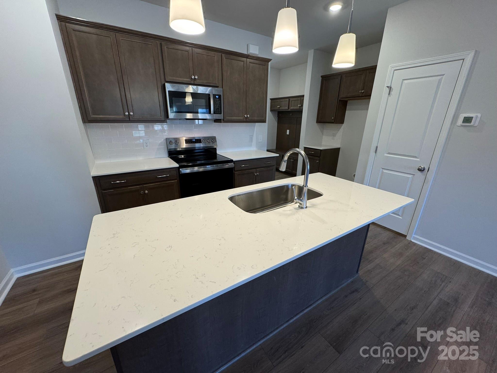 4750 Lakeview Road, Unit 18 Charlotte, NC 28216 - Photo 15 of 46 a kitchen with granite countertop a sink a stove and refrigerator