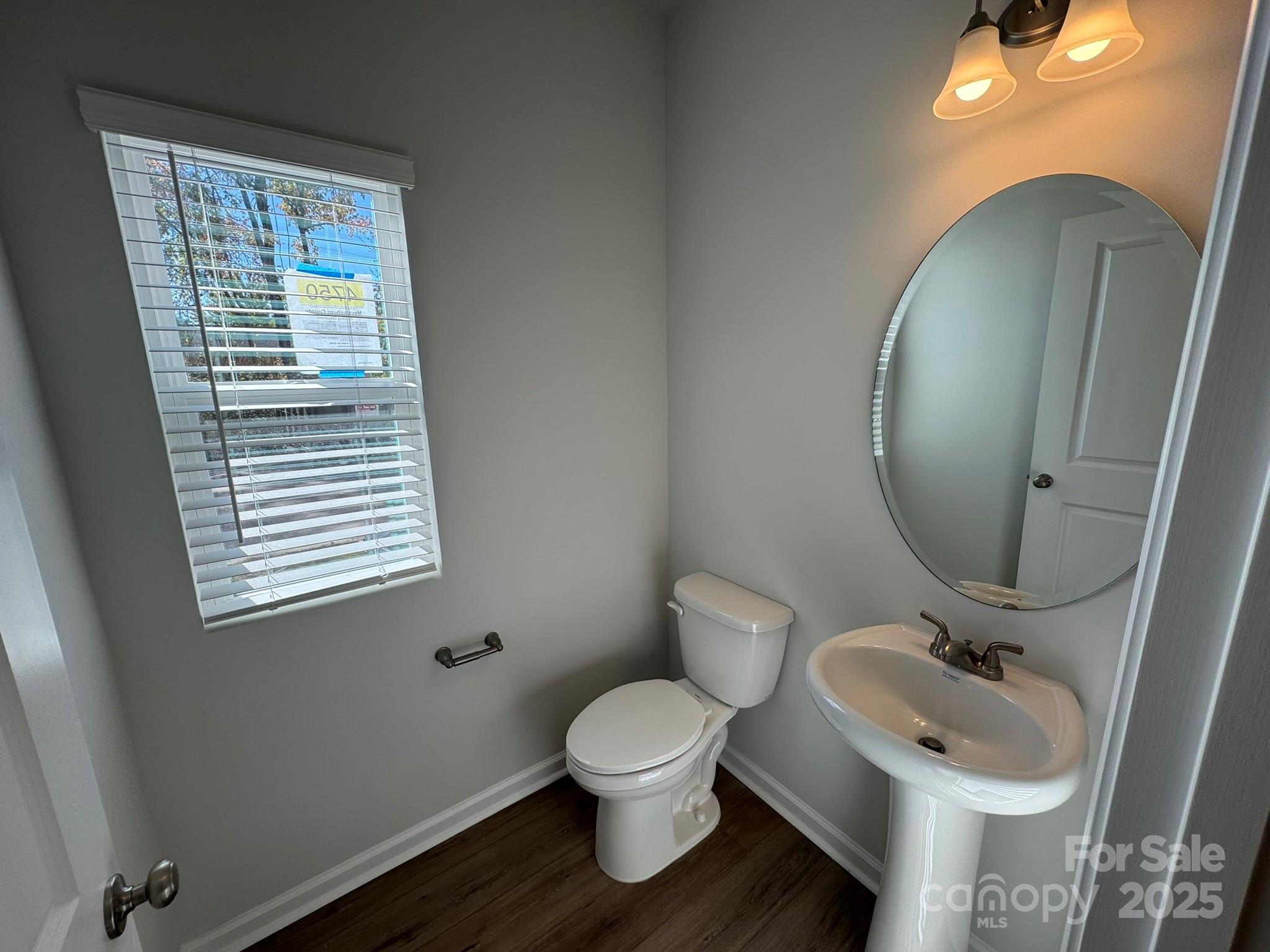 4750 Lakeview Road, Unit 18 Charlotte, NC 28216 - Photo 22 of 46 a bathroom with a toilet sink and mirror