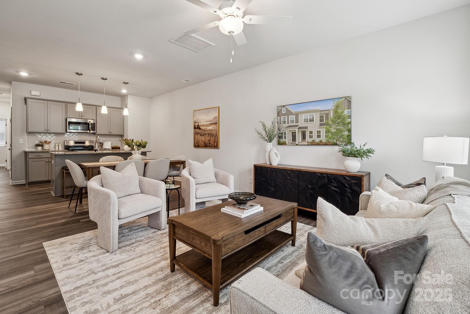 4750 Lakeview Road, Unit 18 Charlotte, NC 28216 - Photo 6 of 46 a living room with furniture and a chandelier