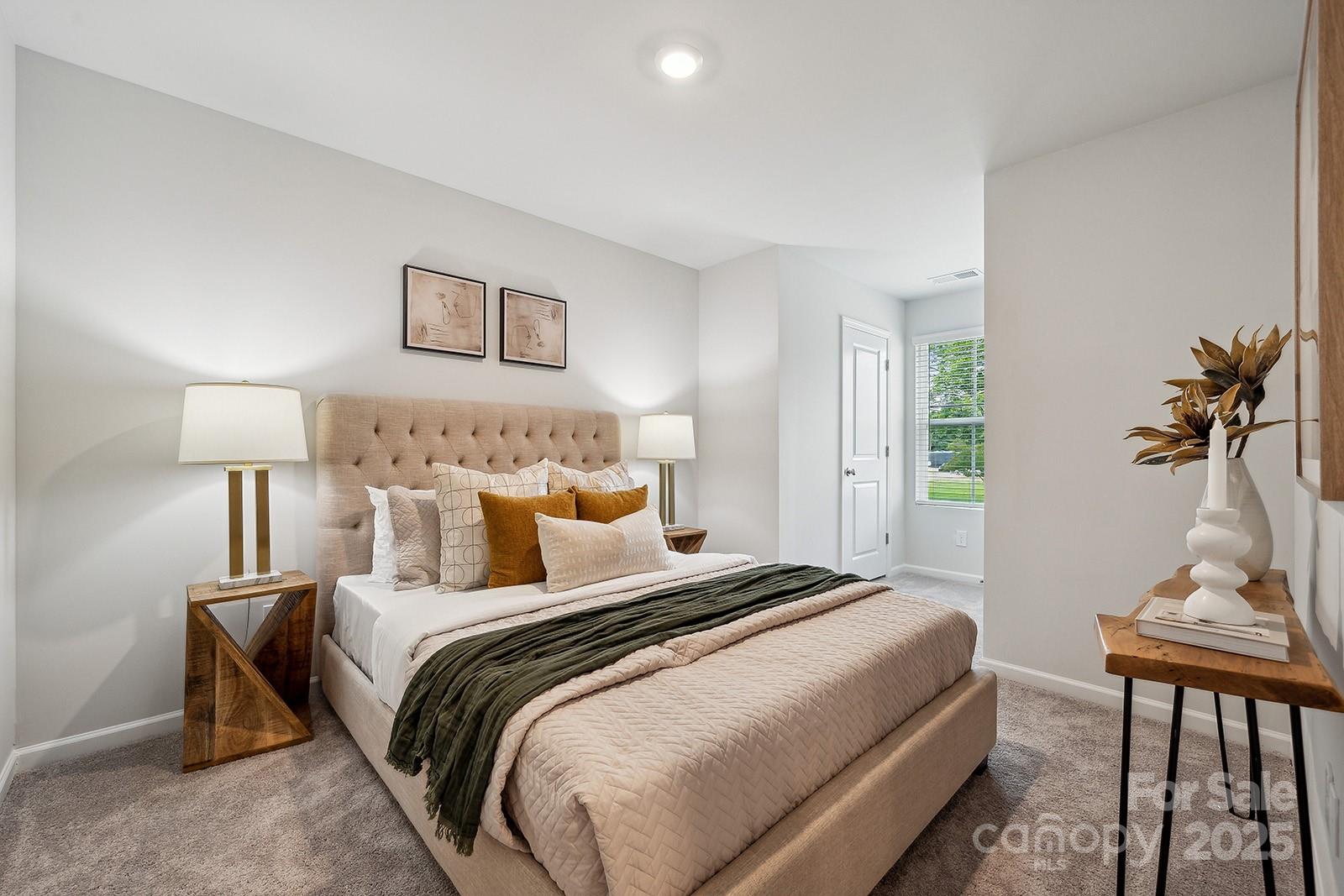 4750 Lakeview Road, Unit 18 Charlotte, NC 28216 - Photo 9 of 46 a bed room with a bed and a lamp