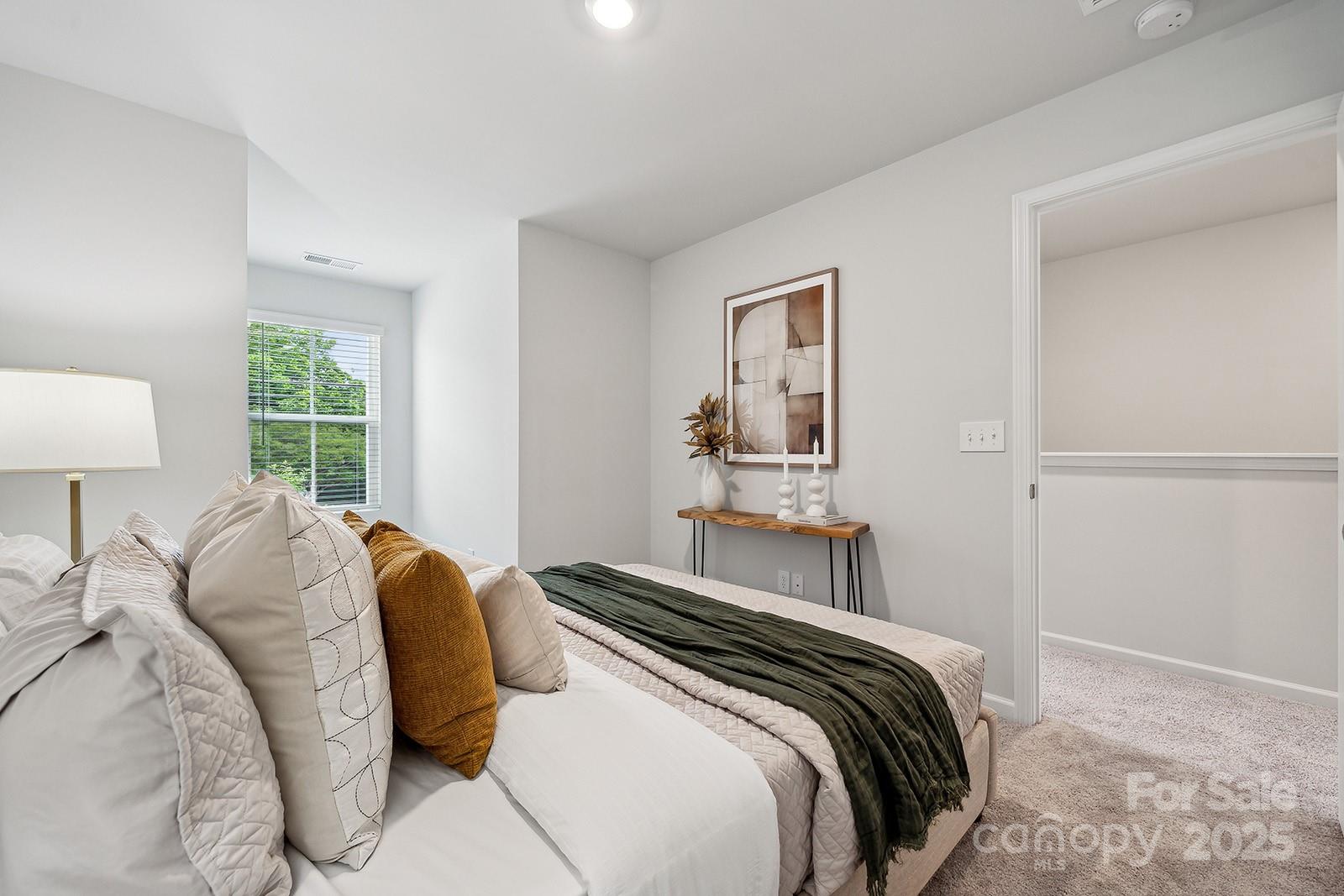 4750 Lakeview Road, Unit 18 Charlotte, NC 28216 - Photo 10 of 46 a bedroom with a bed and a lamp