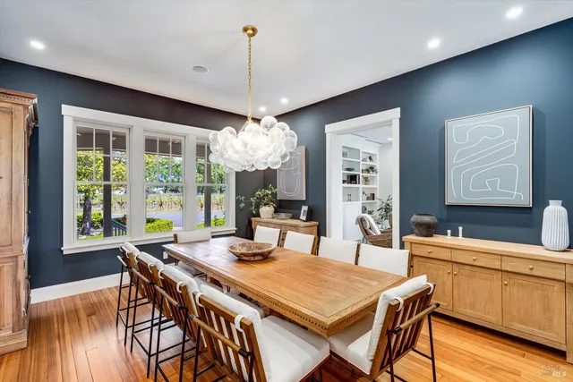 a view of a house with a yard and a large tree