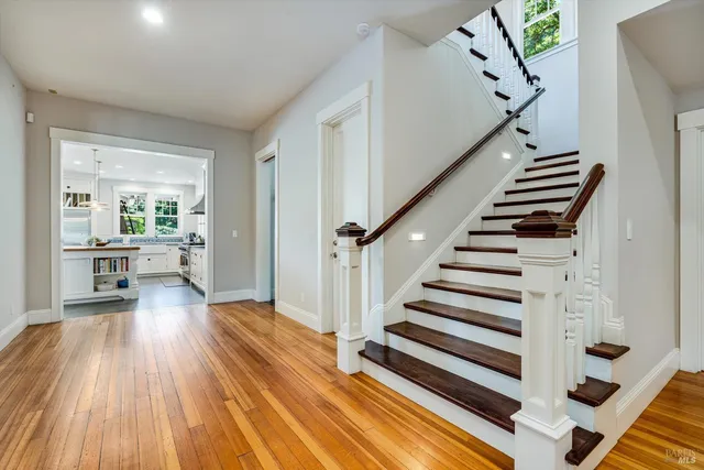 a bedroom with a bed and a dresser next to a window