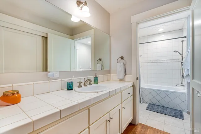 a view of a patio with table and chairs with wooden floor and fence