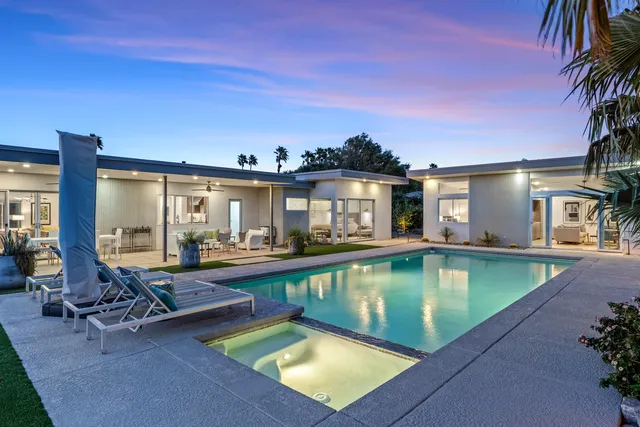 a view of a patio with swimming pool table and chairs